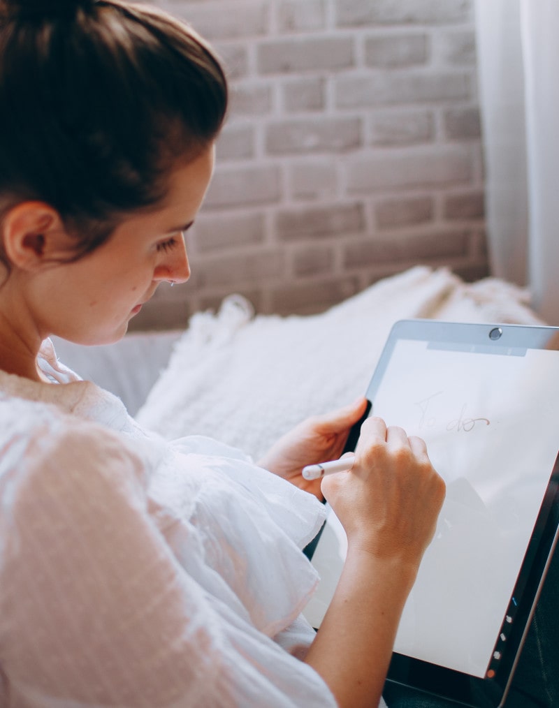 Woman jotting down notes at a Denver dispensary