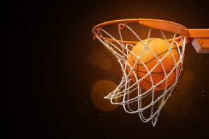 a basketball in the net on a dark background